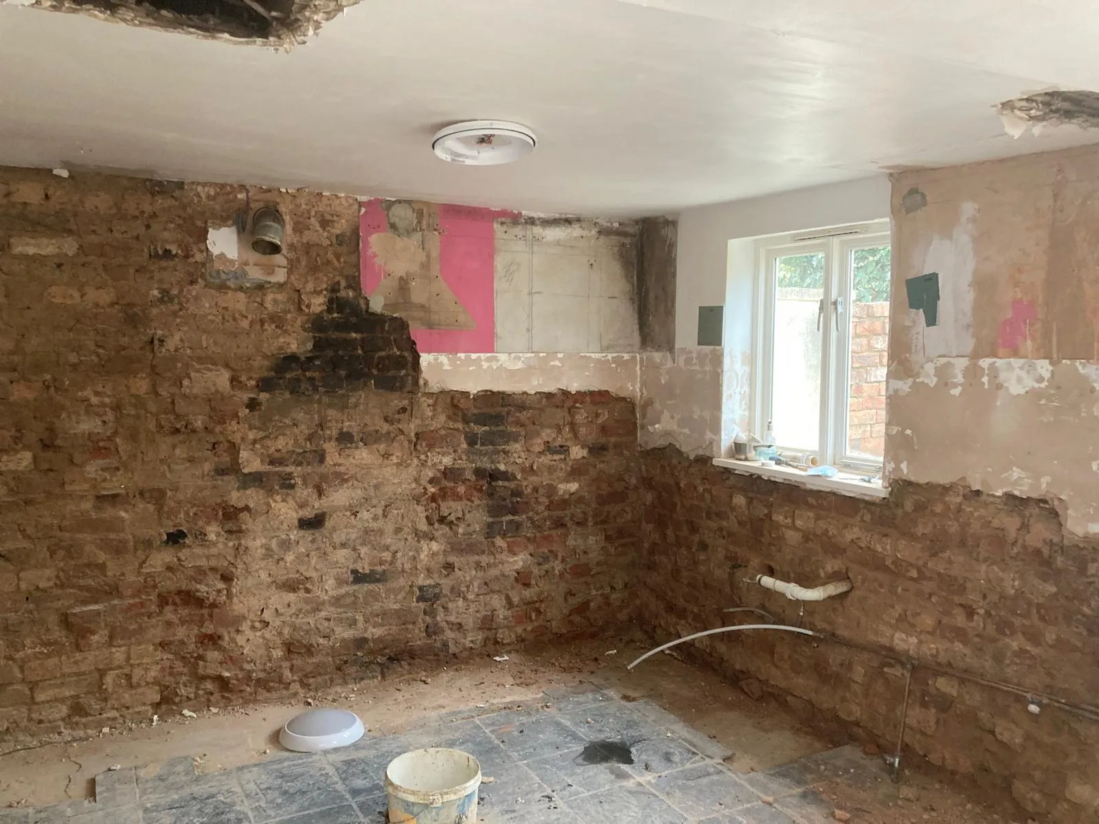 Empty kitchen ripped back to the brickwork awaiting a full refresh