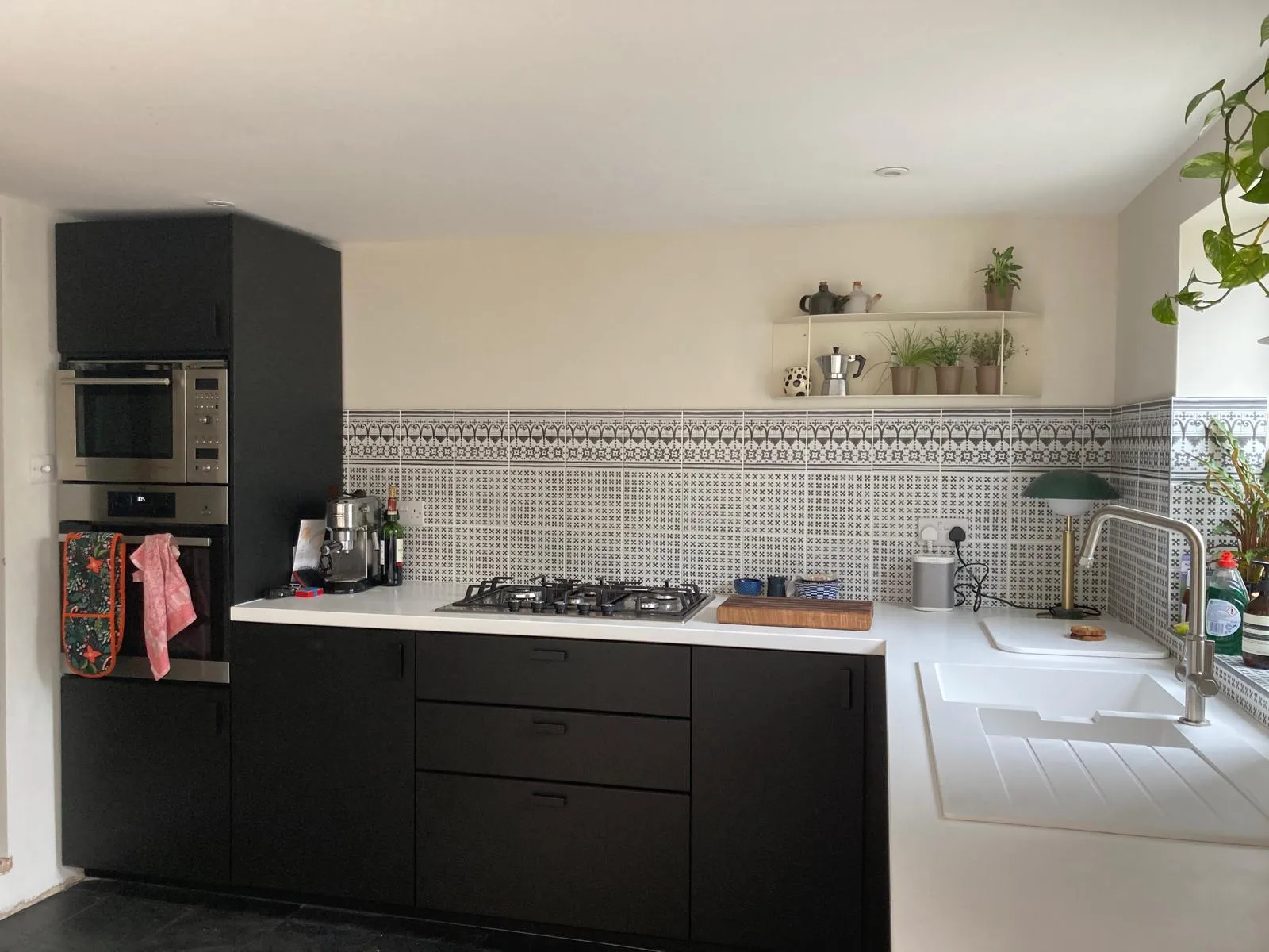Newly fitted sleek kitchen with patterned tiling