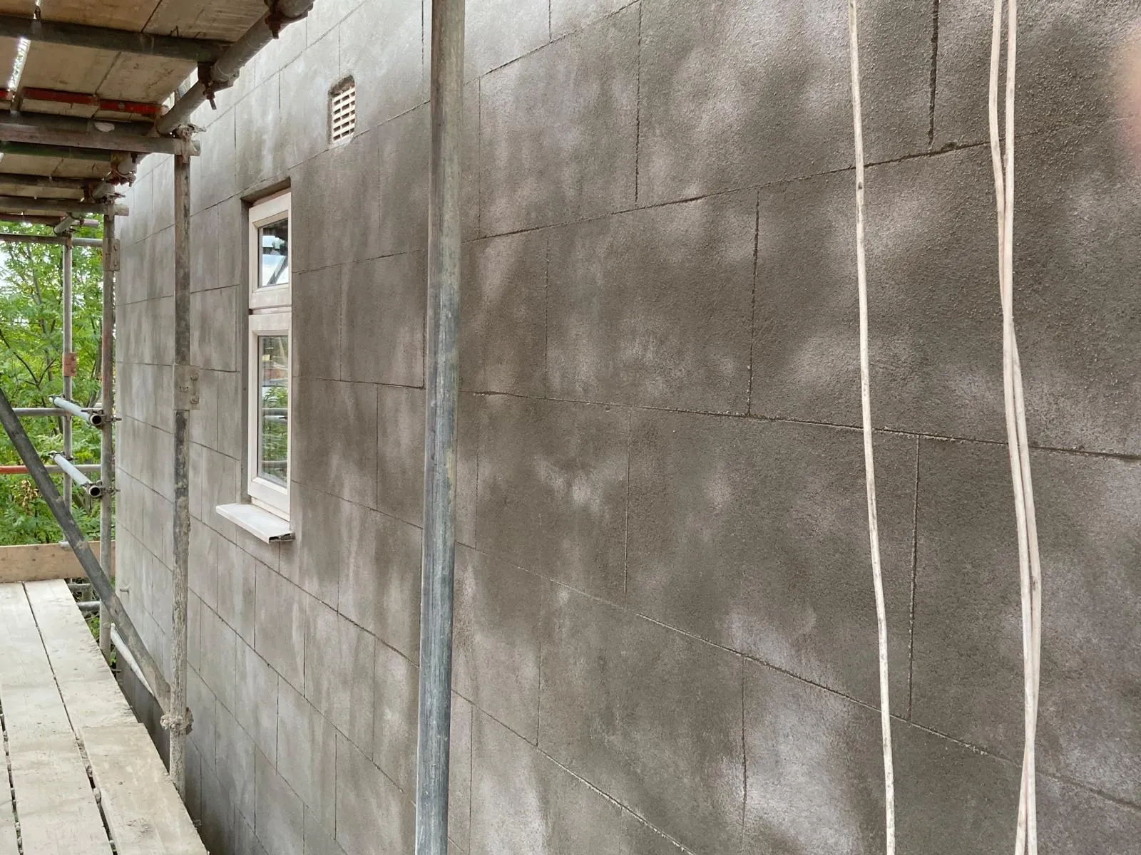 New rendering applied over top of uneven brickwork