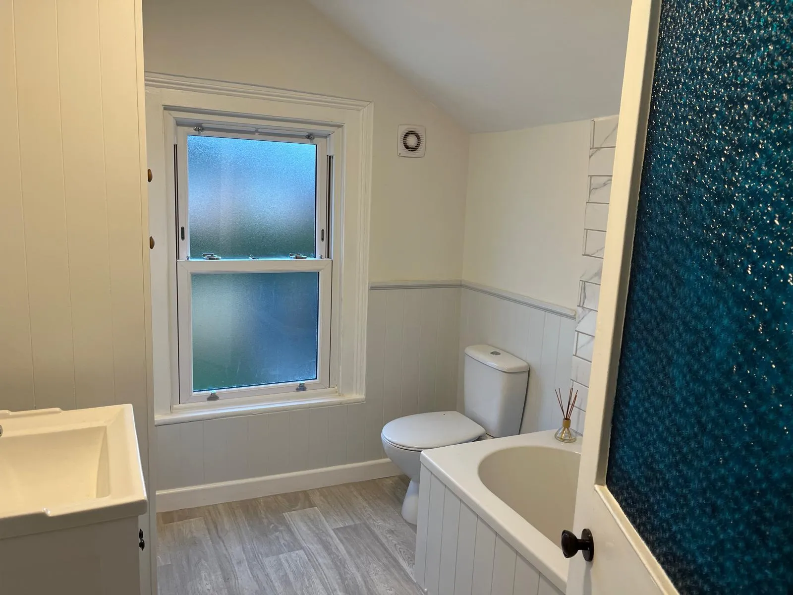 Newly tiled bathroom with fresh UPVC sash window