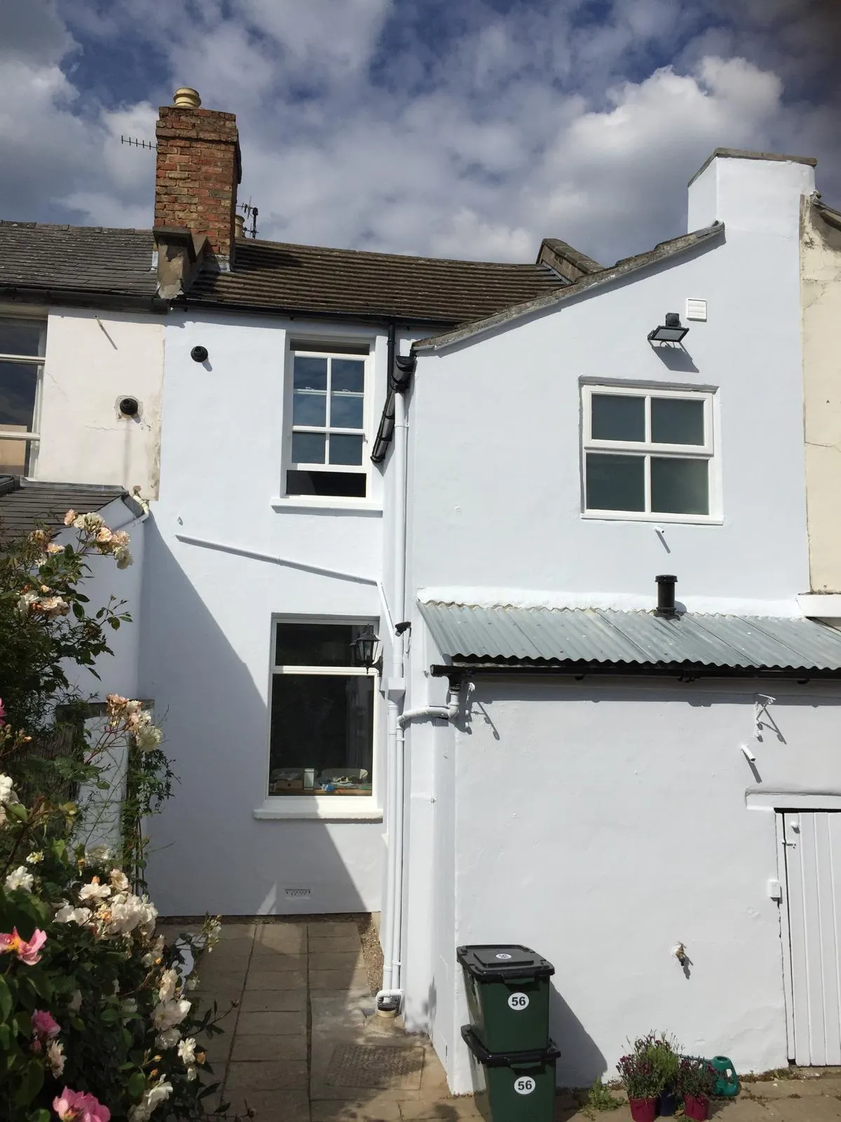Freshly rendered and painted white cottage rear exterior