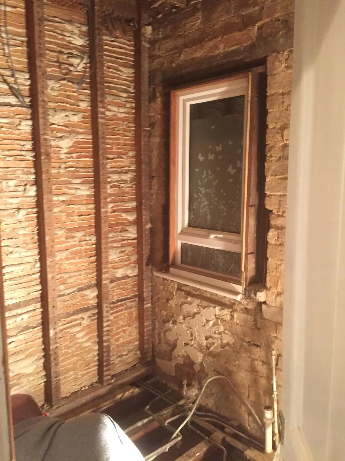 Partly refurbished bathroom with panel removed from bath