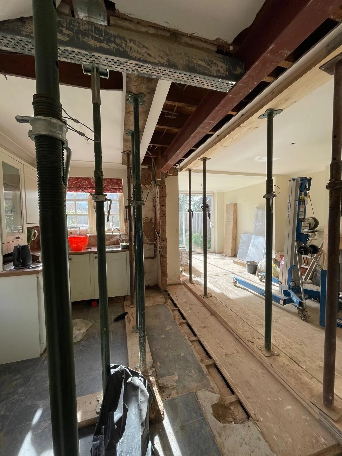 Steel beam installed with props during open-plan structural work