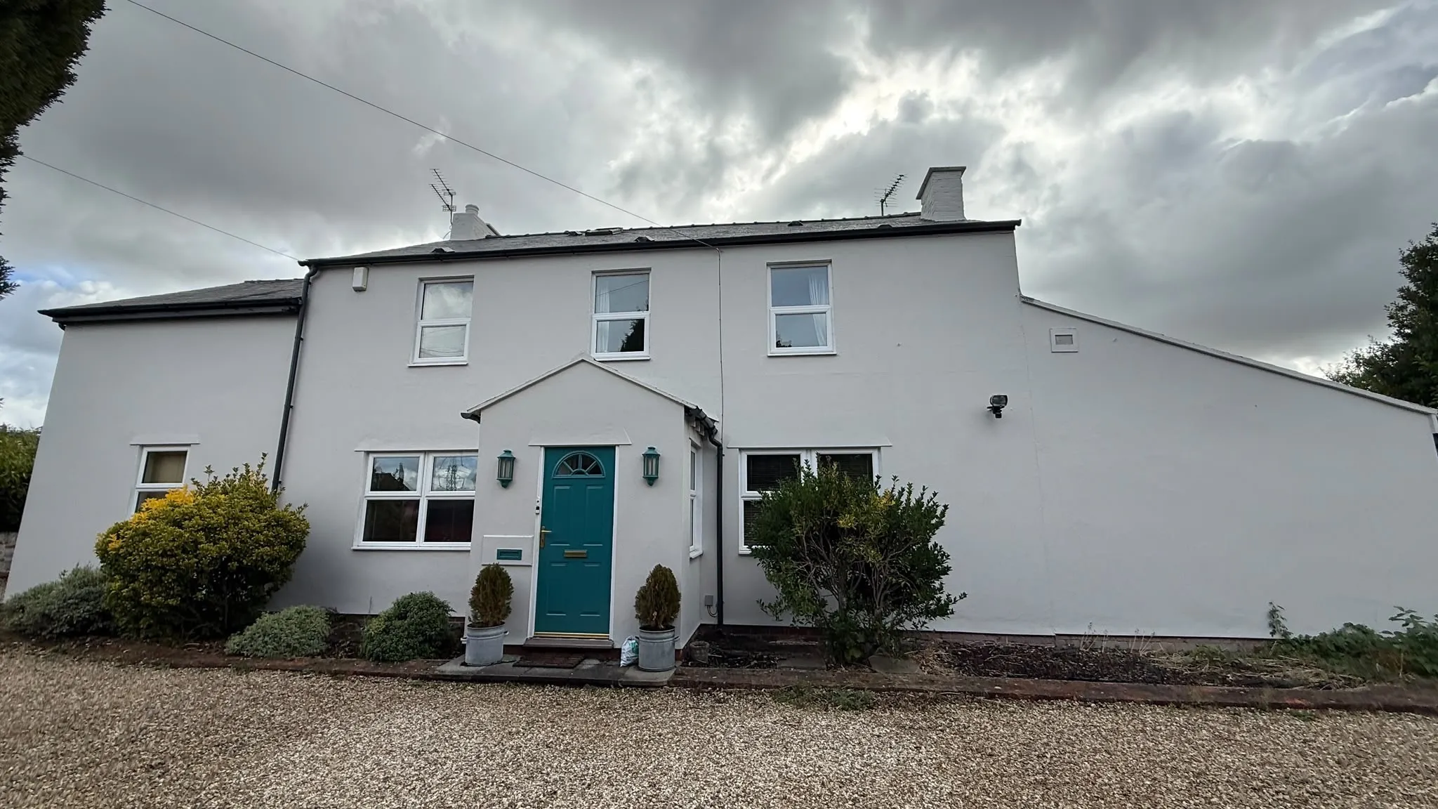 Redecorated rendered exterior with teal front door