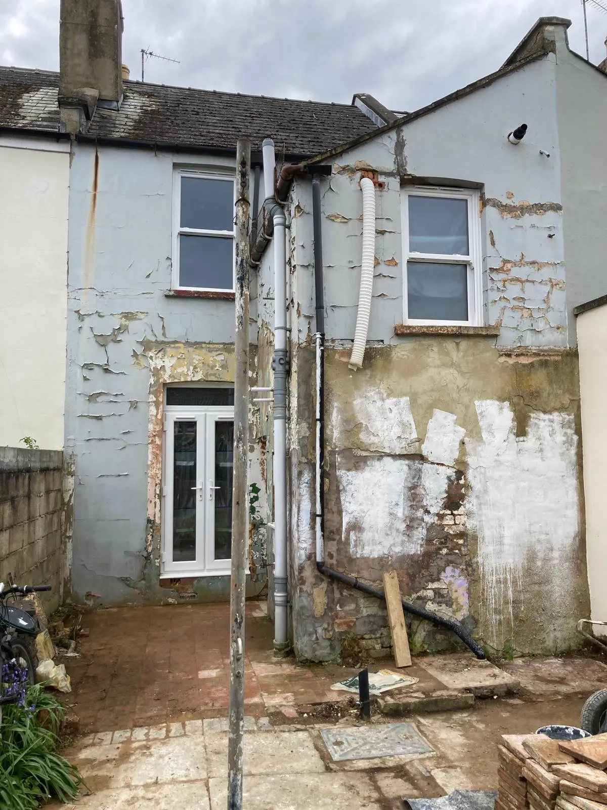 Rear elevation with failing render stripped back awaiting repair
