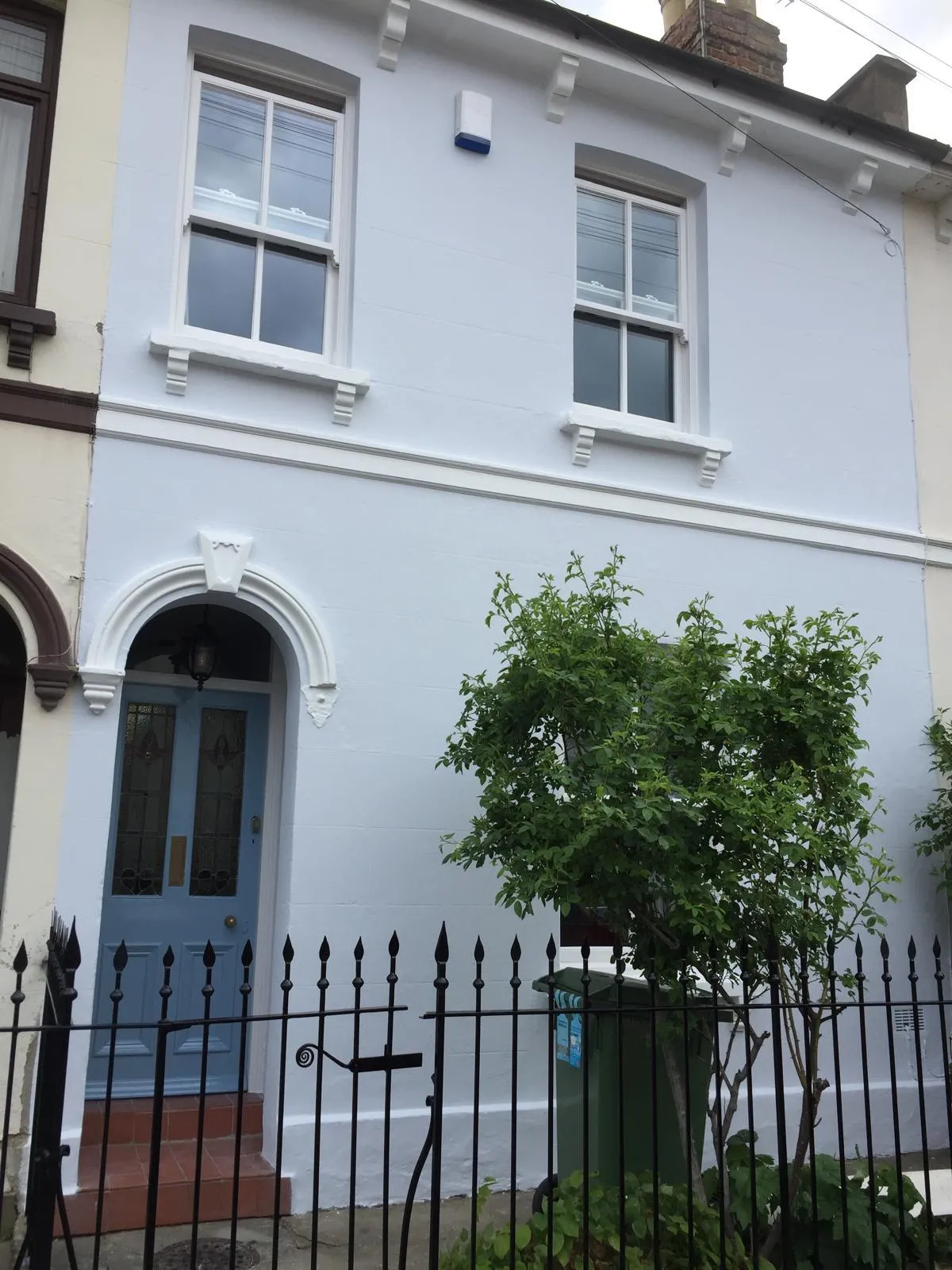 Freshly painted Victorian terrace facade with smart front door
