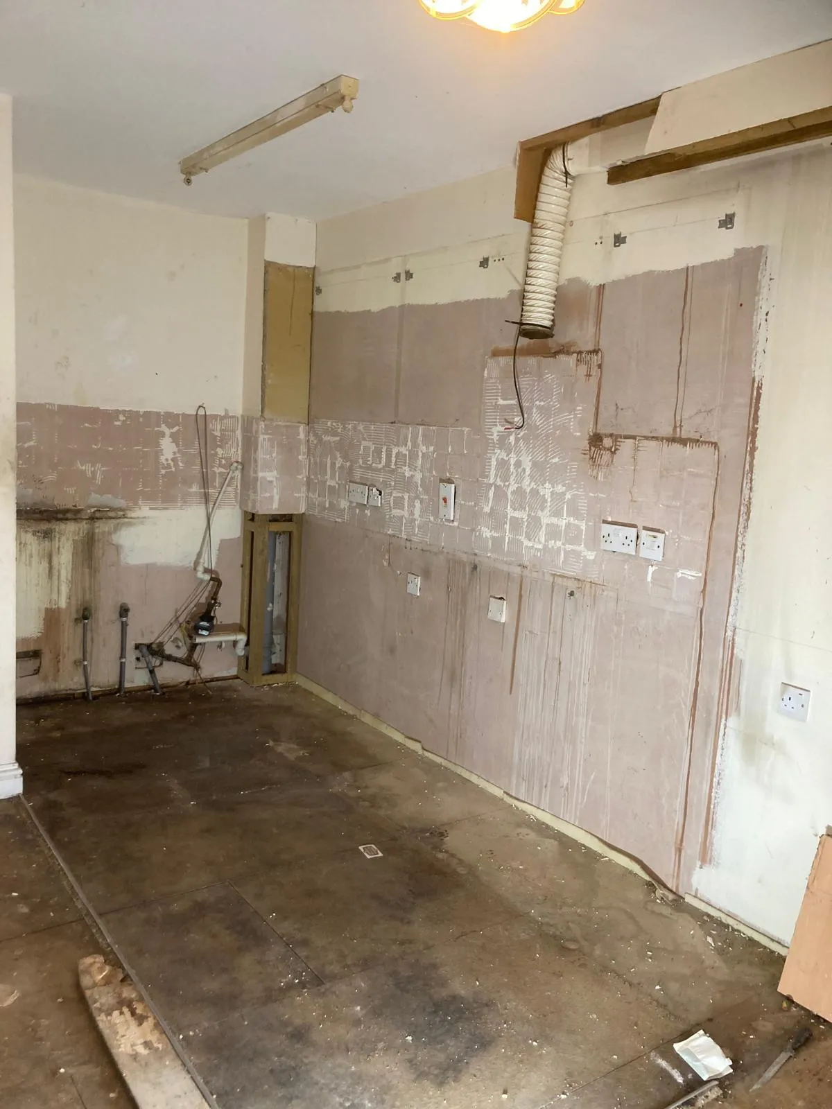 Kitchen stripped back to plaster, ready for new units