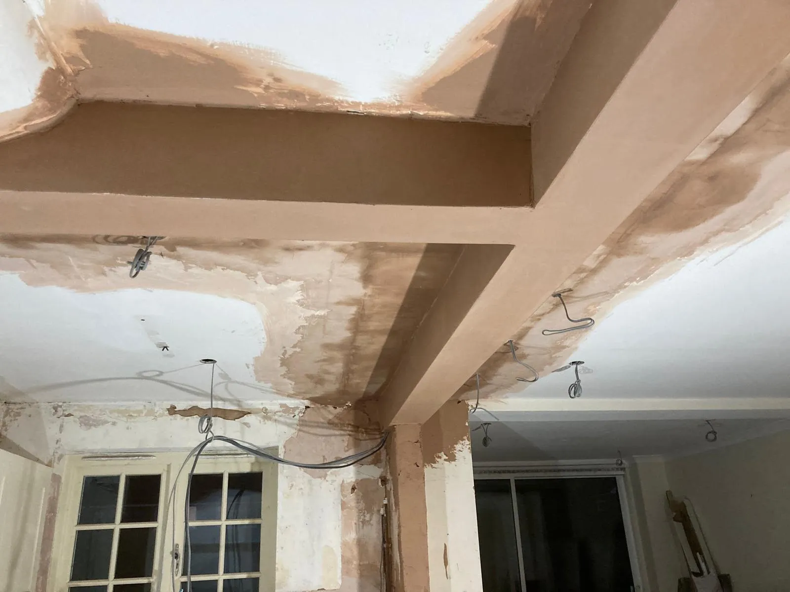 Freshly plastered ceiling and boxed beams ready for decoration