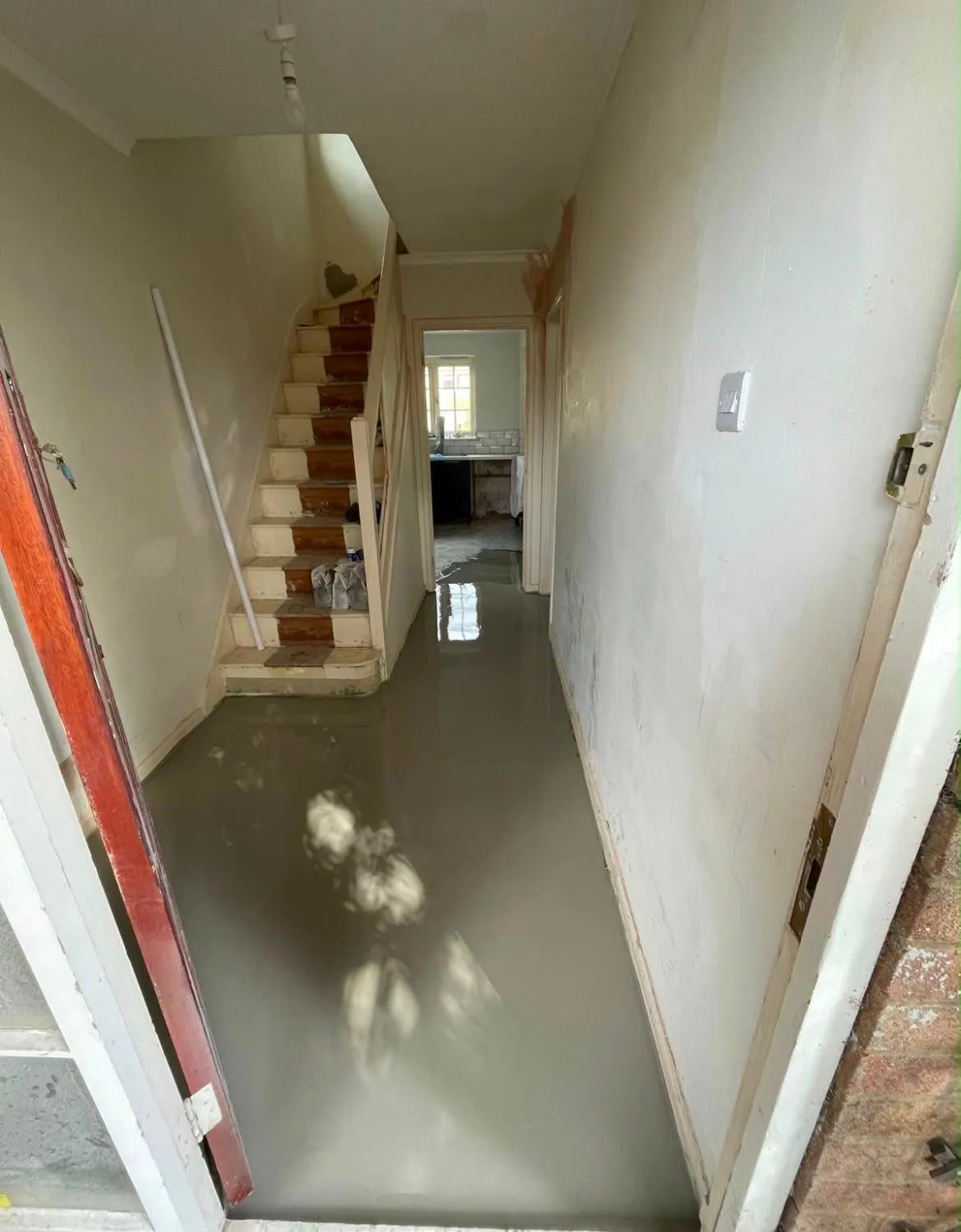 Self-levelling compound poured across the entranceway floor